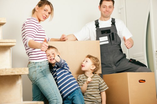 Office relocation team handling desks and IT equipment